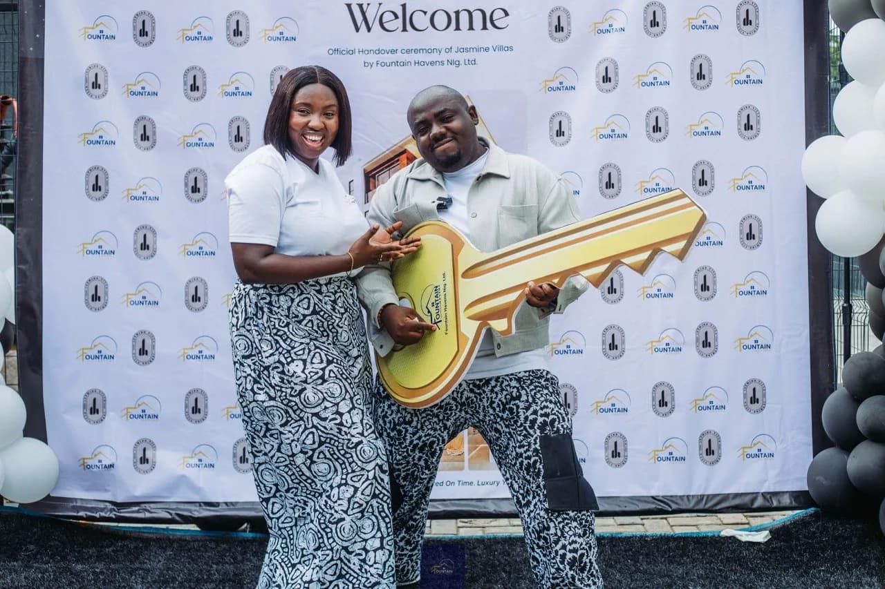 Homeowners receiving the ceremonial key to their home